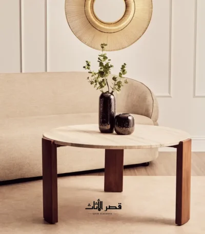 طاولة قهوة من حجر الترافرتين أمام أريكة فاتحة