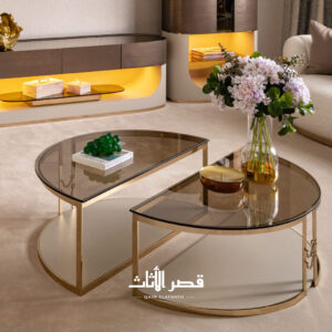 طاولة قهوة بتصميم منحني من الزجاج الملون على إطار معدني مصقول